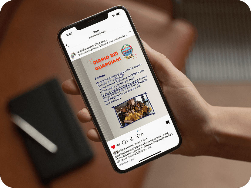 User holding a smartphone showing a social media post from the Guardiani University editorial plan