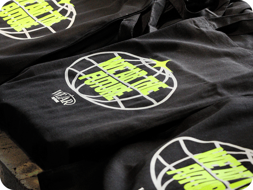 Black custom event merchandise including staff t-shirts and tote bags